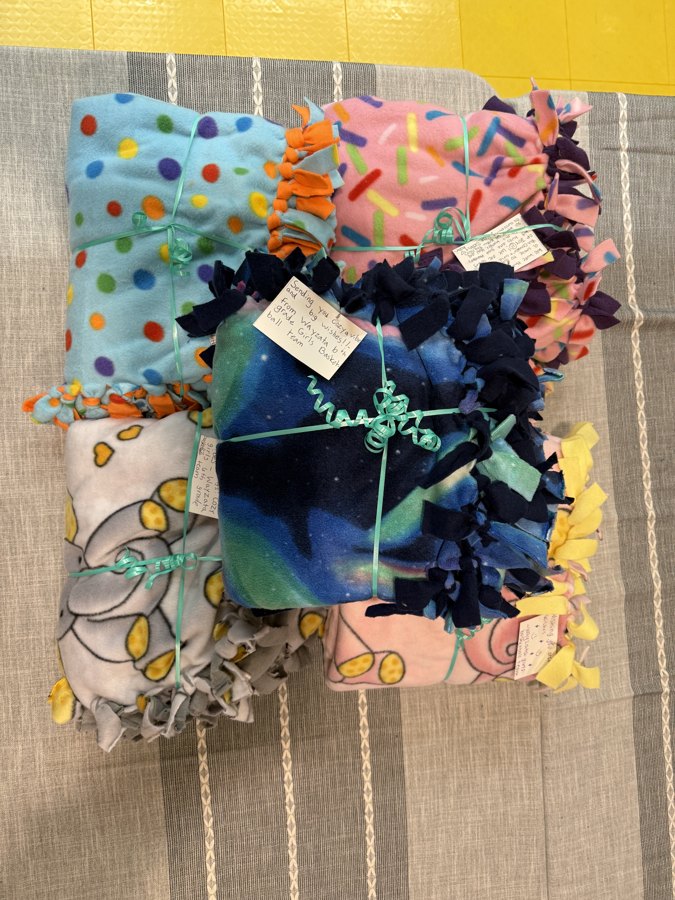 Finished fleece tie blankets bundled with handwritten notes