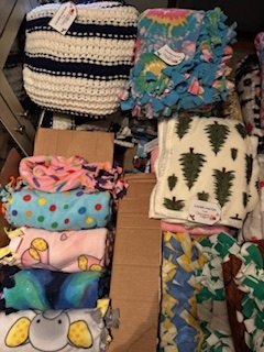 Folded patterned blankets ready to give