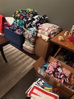A collection of handmade blankets arranged on furniture