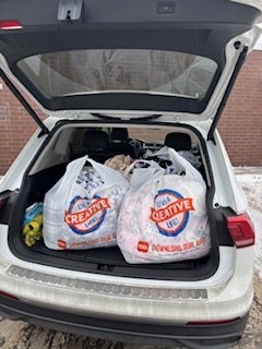 A car packed with bags of donations