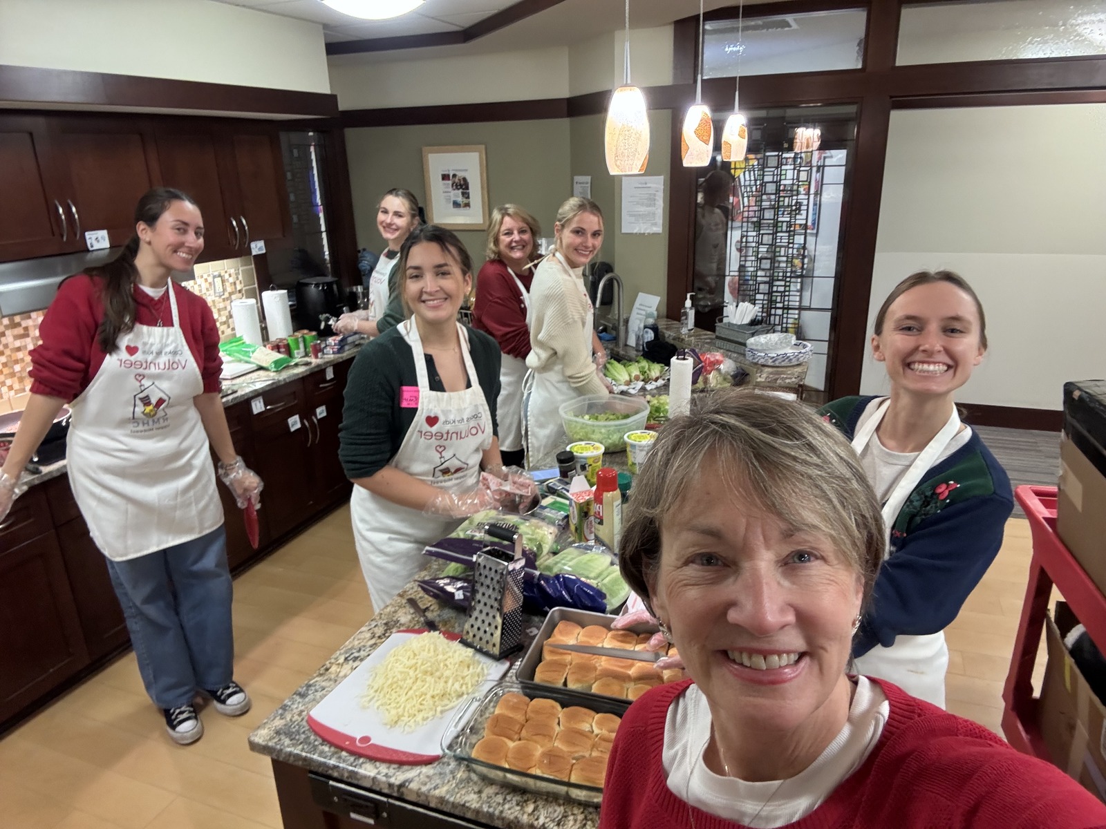 Volunteers smiling together while preparing food